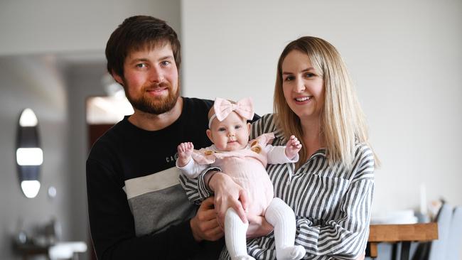 Brittany Harvey and husband Gered with baby Halle at home. They will drive to Broken Hill where she will be shown off to relatives and family for the first time after South Australian border restrictions are lifted. Picture: NCA NewsWire/David Mariuz