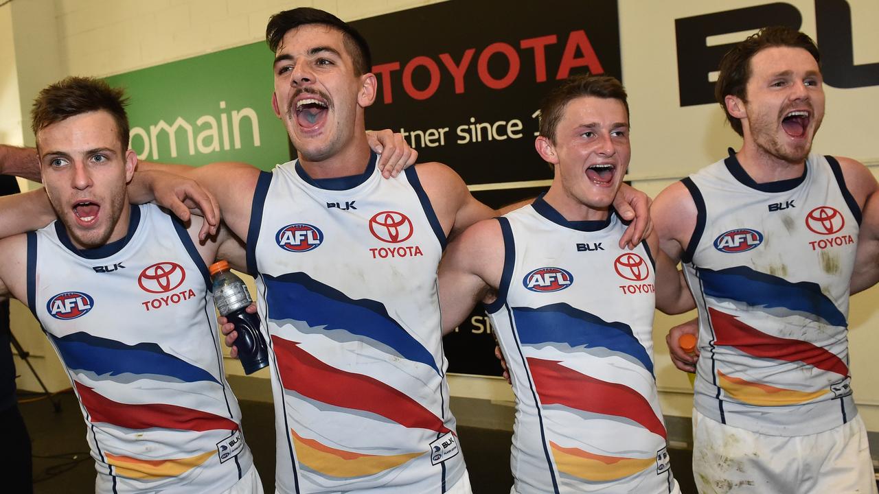 Adelaide Crow Brodie Smith, left, celebrates the 2015 second elimination final win over the Western Bulldogs with Taylor Walker, Matt Crouch and Patrick Dangerfield.