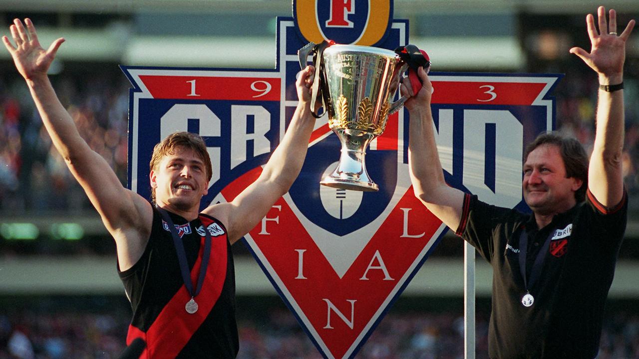 Footballer Mark Thompson holding up premierhsip cup with coach Kevin Sheedy. AFL football - Carlton vs Essendon grand final match 25 Sep 1993.