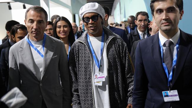 Former Brazilian football star Ronaldinho Gaucho walks among the country pavilions at COP29, which should stand for “Cost of the Party”. Picture: Sean Gallup/Getty Images