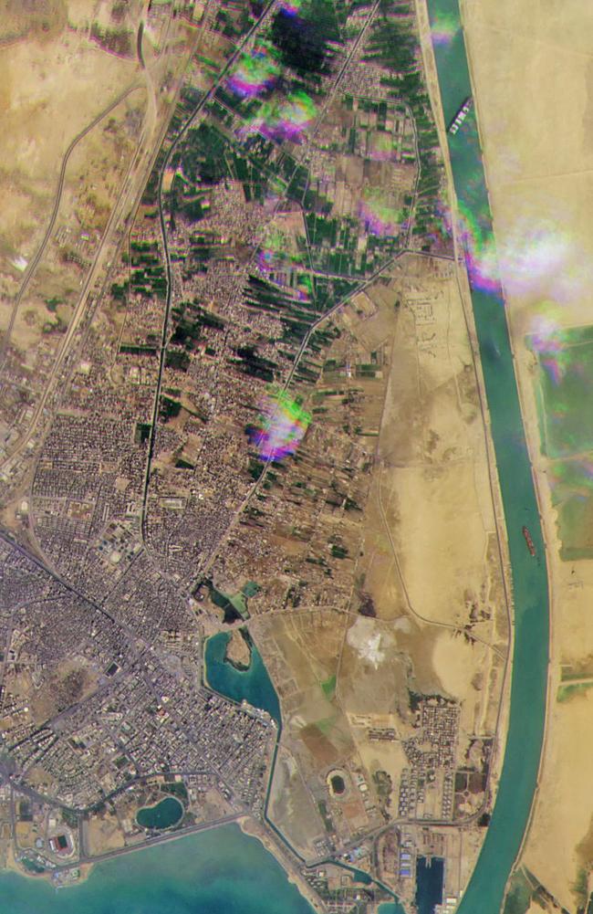 The vessel seen at the top of this satellite image, is lodged sideways and impeding all traffic across the waterway of Egypt's Suez Canal. Picture: Planet Labs/AFP