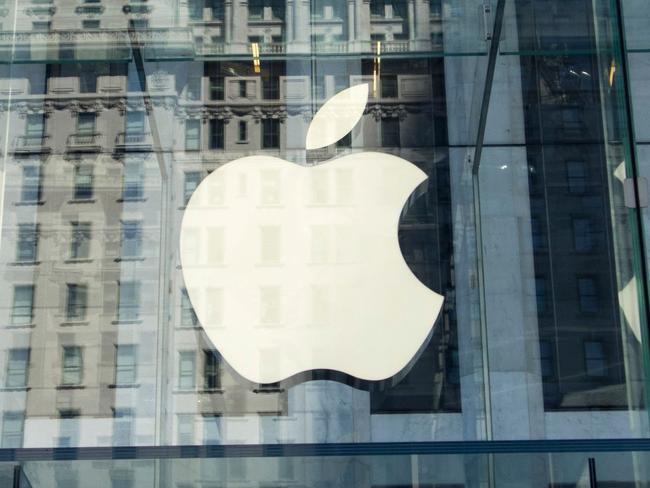 (FILES) This file photo taken on September 14, 2016 shows the Apple logo at the entrance to the Fifth Avenue Apple store in New York. Apple announced January 17, 2018 it would pay some $38 billion in taxes -- likely the largest payment of its kind -- on profits repatriated from overseas as it boosts investments in the United States.The iPhone maker said in a statement it plans to use some of its foreign cash stockpile of more than $250 billion, which qualifies for reduced tax rates under a recent bill, to invest in new projects, with estimated investments of $75 billion in the US. / AFP PHOTO / Don EMMERT