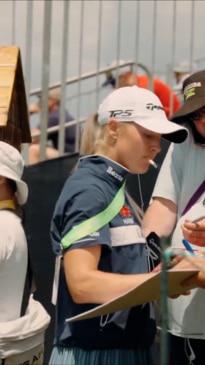 Golf star smokes cigarette while signing autographs