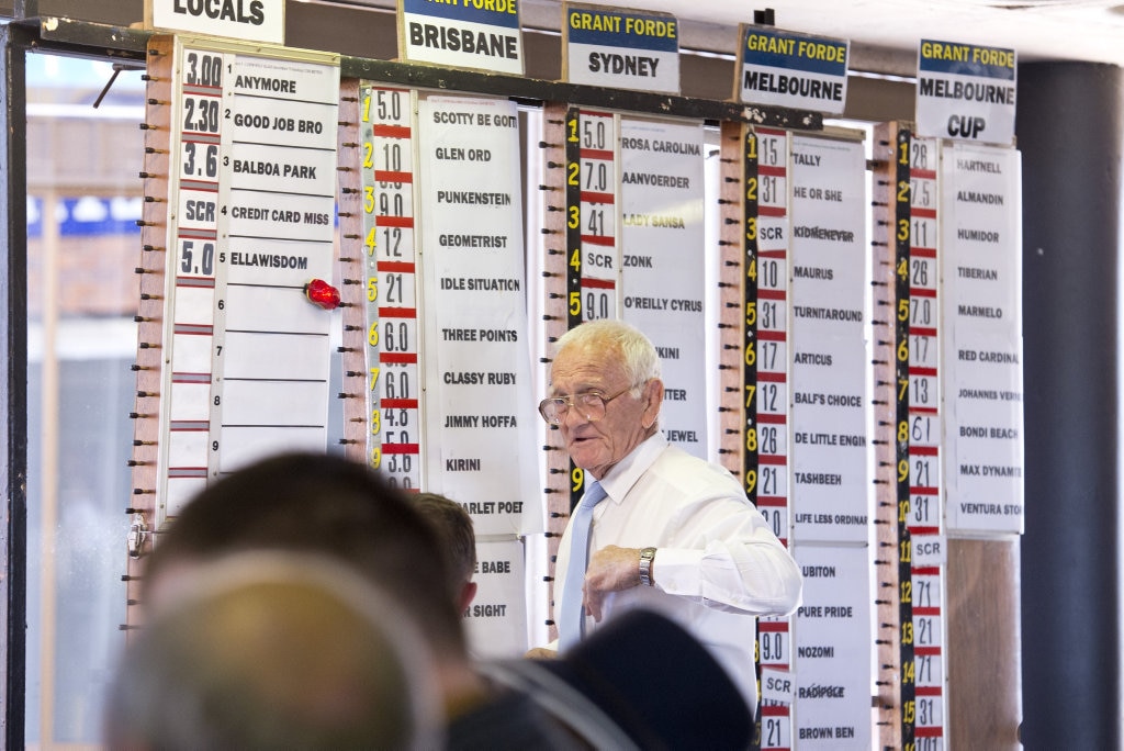 John Forde works the numbers on Melbourne Cup day at Clifford Park, Tuesday, November 7, 2017. Picture: Kevin Farmer