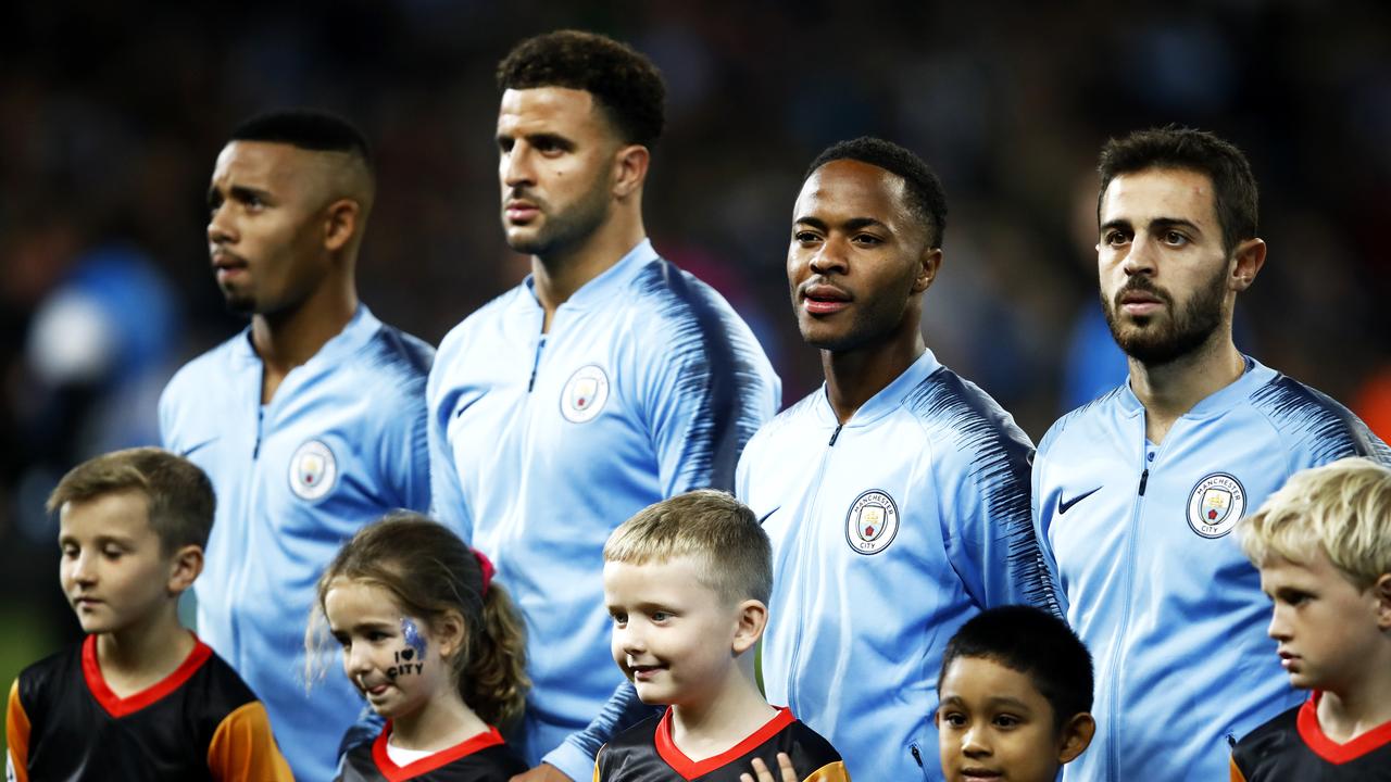 The Manchester City players look on as the supports show their disdain for the Champions League anthem.