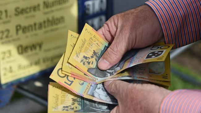 A bookmaker counts money ahead of the Melbourne Cup.