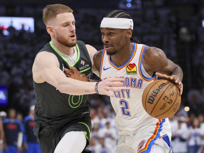 Oklahoma City Thunder guard Shai Gilgeous-Alexander (2) drives against Minnesota Timberwolves guard Donte DiVincenzo (0) during the second half of Game 1 of an NBA basketball Western Conference Finals playoff series Tuesday, May 20, 2025, in Oklahoma City. (AP Photo/Nate Billings)