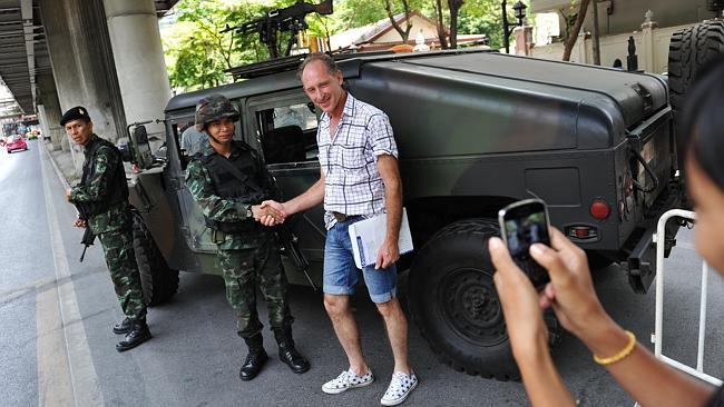 A foreign tourist with Thai soldiers deployed on a downtown Bangkok street. Picture: Getty