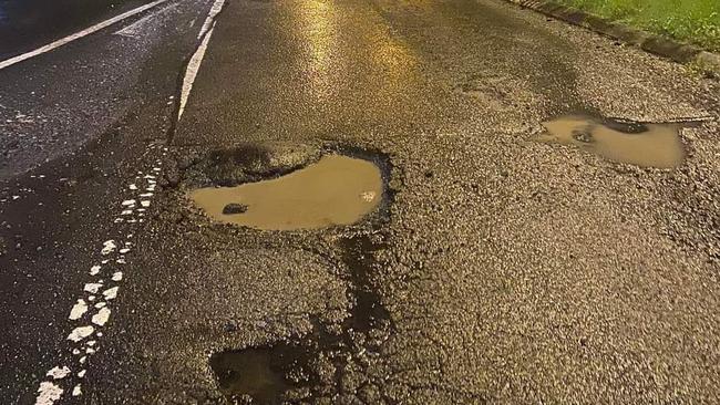 A photo of particularly bad potholes on Mona Vale Rd.