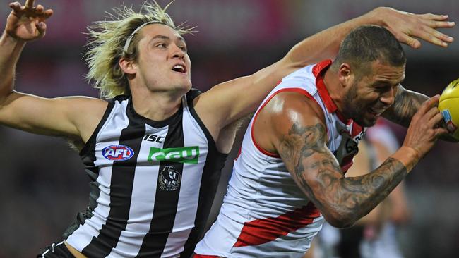 Magpie Darcy Moore attempts to spoil Lance Franklin before his injury.