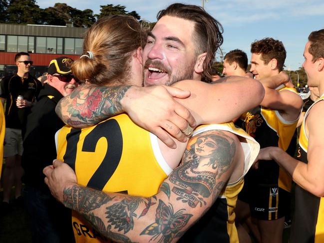 Stonecat Kyle Hutchison embraces premiership teammate Matt La Fontaine (number 12). Picture: Mark Dadswell