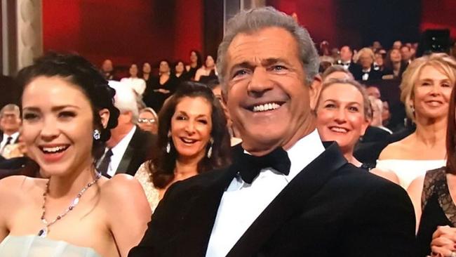 Mel Gibson reacts to Kimmel’s shout out during the Oscars opening monologue.