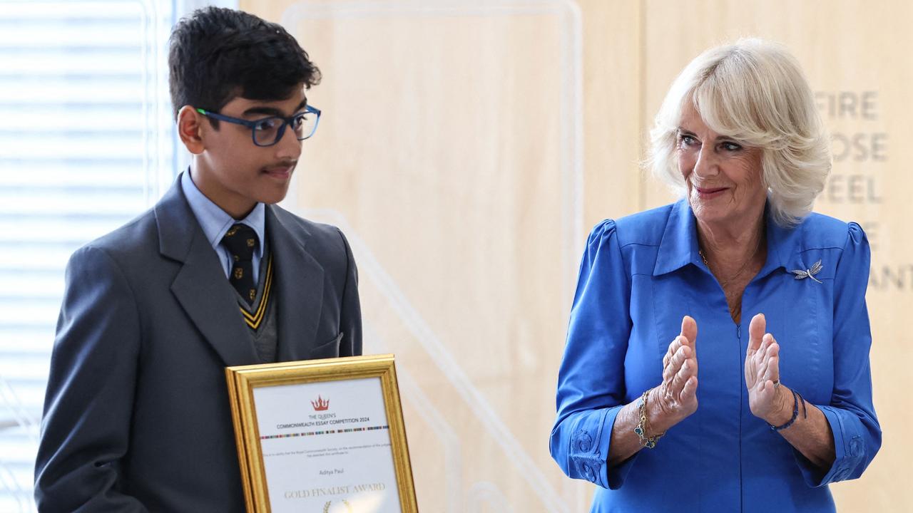 Britain's Queen Camilla applauds current Bee champion Aditya Paul and other Commonwealth Essay Competition past finalists during the presentation at Green Square Library in Sydney on October 22, during the six-day royal visit to Sydney and Canberra. Picture: David Gray/ POOL/AFP