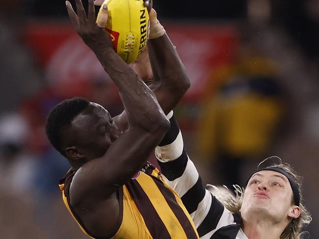 Mabior Chol of the Hawks and Darcy Moore of the Magpies compete in the ruck. Picture: Darrian Traynor/Getty Images.