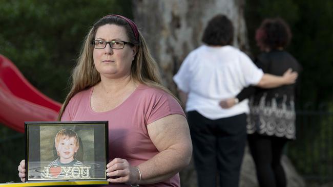 Adelaide mums Deborah (foreground, holding a photo of her son when he was a child), Kate and Evie each lost their sons and say they were failed by the state’s mental health system. Picture: Naomi Jellicoe