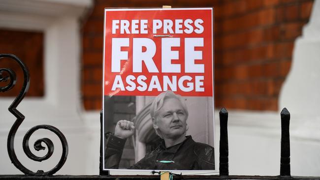 A supporter of WikiLeaks founder Julian Assange holds a placard outside the Ecuadorian Embassy in London in 2019. Picture: AFP