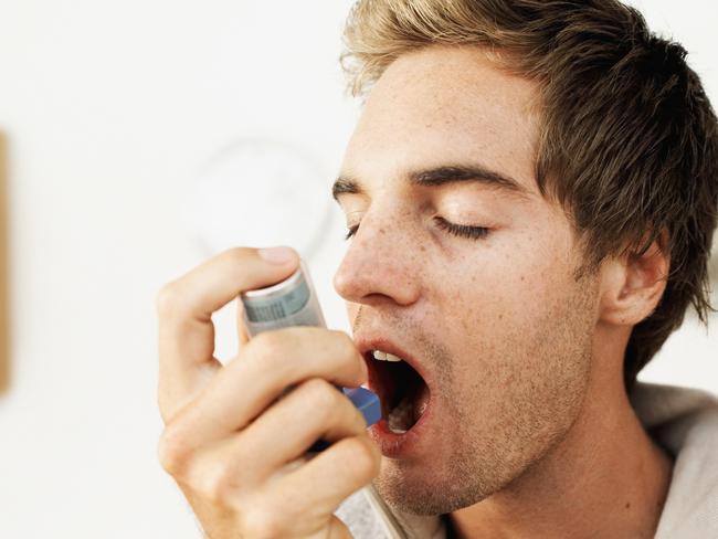 Close-up of a man using an inhaler. Asthma inhaler. Thinkstock.