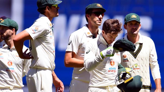 Tim Paine leads the Australian team from the field after losing the second Test against India at the MCG Picture: AFP