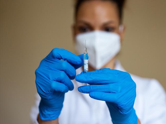 Close-up of a female doctor preparing a COVID-19 vaccine injection for vaccination. Preparation of a coronavirus vaccine dose.