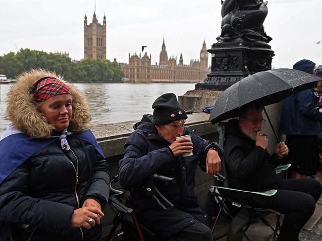 Members of the public queue in the rain along the south bank of the River Thames, opposite the Palace of Westminster, home to Westminster Hall and the Houses of Parliament as they wait to pay their respects when Queen Elizabeth II Lies in State. Picture: AFP