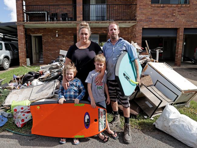 Girards Hill’s Aaron and Elise Taylor evacuated themselves and kids Nash, 7, and Finn, 4, on bodyboards. Picture: Toby Zerna