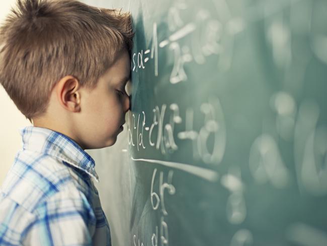 Little boy in math class overwhelmed by the math formula.