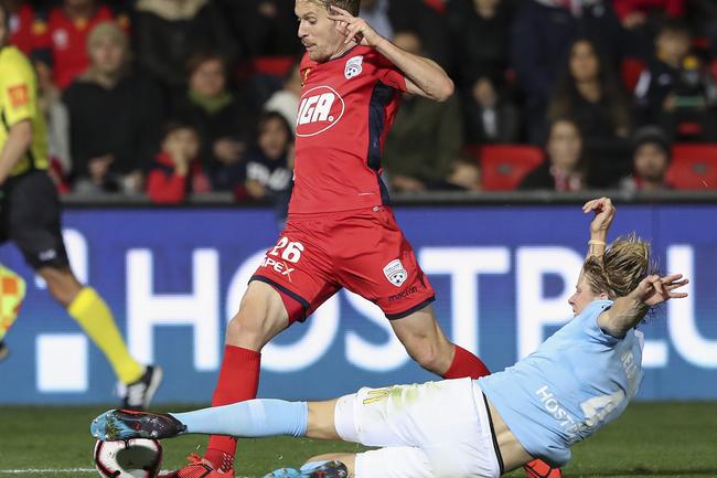 Adelaide’s Ben Halloran beats Melbourne City’s Harrison Delbridge in the A-League elimination final at Coopers Stadium.. Picture SARAH REED