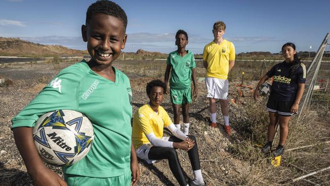 Zak Yusuf (9), Abdulamilk Yusuf (14), Yussuf Hussein (11), Flynn Slater (15) and Madison Pavez (13) in the spot where a new soccer facilities will be built in Tarneit. Picture: Jake Nowakowski