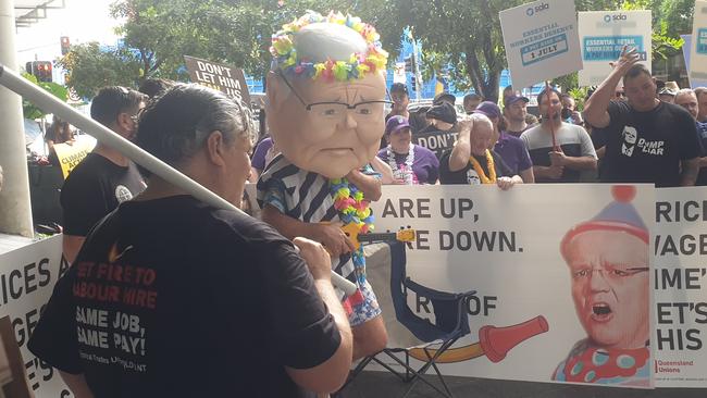 One man was seen donning a giant plastic Scott Morrison head who was playing a ukulele. Picture: Ben Graham/ news.com.au