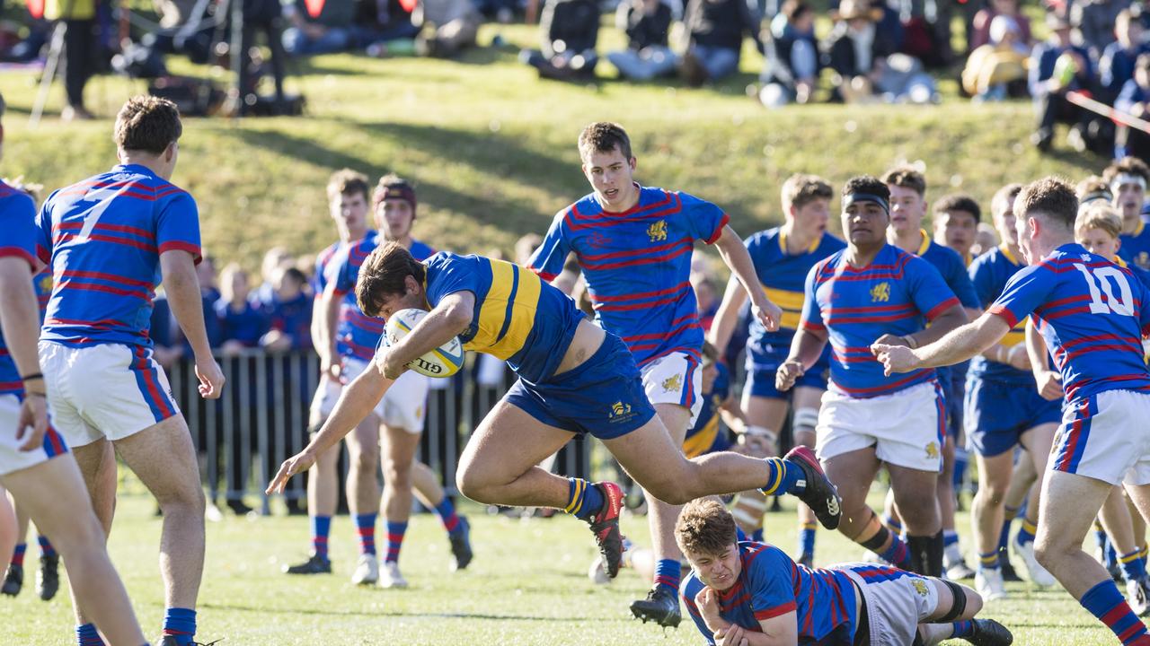 Grammar's Tom Bailey gets away from the Downlands players in O'Callaghan Cup on Grammar Downlands Day at Toowoomba Grammar School, Saturday, August 19, 2023. Picture: Kevin Farmer