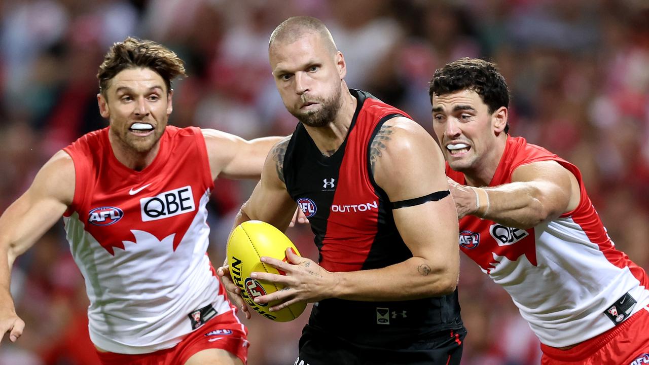 SYDNEY, AUSTRALIA - MARCH 23: Jake Stringer of the Bombers is challenged by Dane Rampe and Tom McCartin of the Swans during the round two AFL match between Sydney Swans and Essendon Bombers at SCG, on March 23, 2024, in Sydney, Australia. (Photo by Matt King/AFL Photos/via Getty Images )