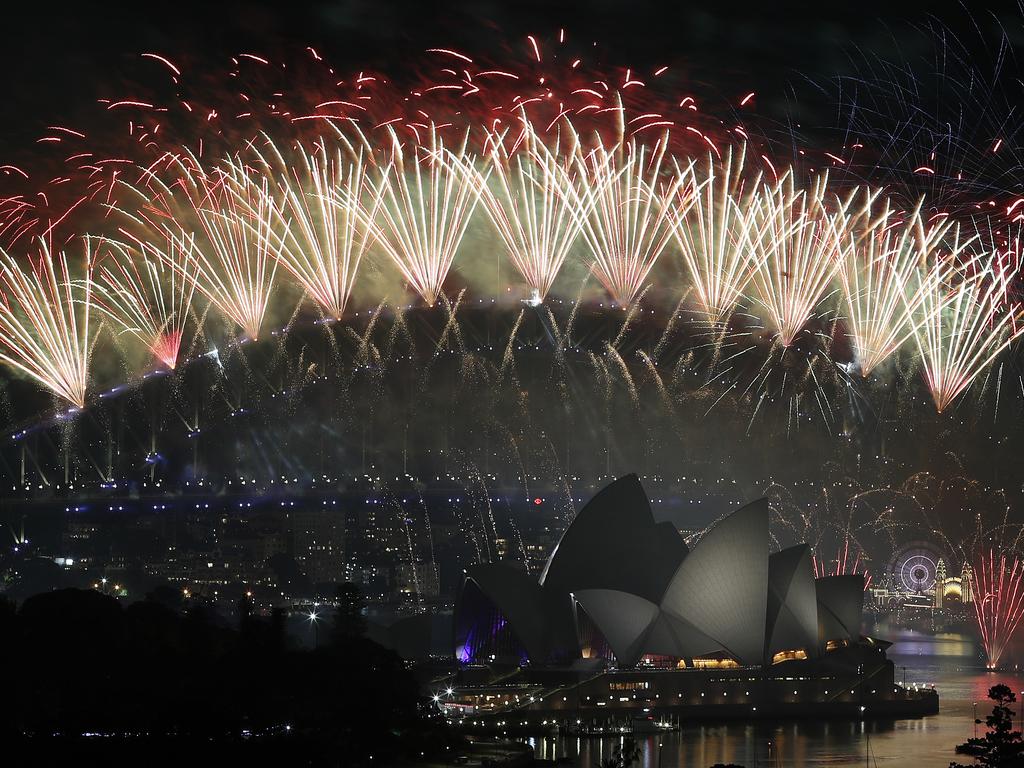 New Year's Eve 2018 - The midnight fireworks display over the Sydney Opera House and Sydney Harbour Bridge from a rooftop in Potts Point. Picture: Toby Zerna