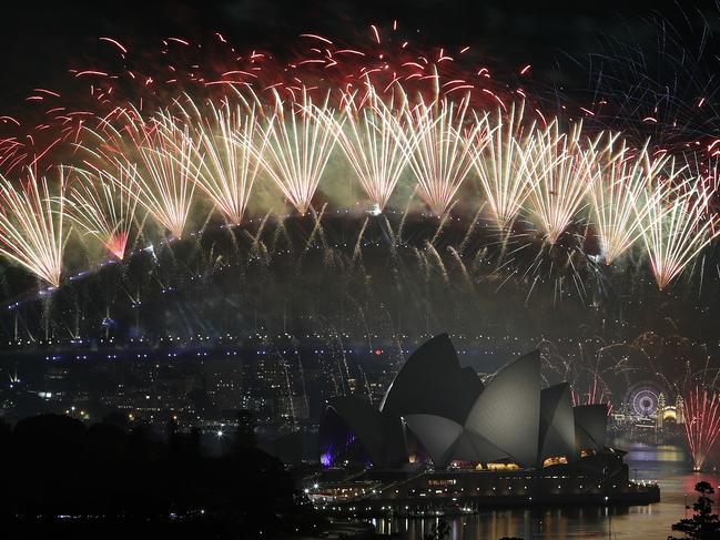 New Year's Eve 2018 - The midnight fireworks display over the Sydney Opera House and Sydney Harbour Bridge from a rooftop in Potts Point. Picture: Toby Zerna