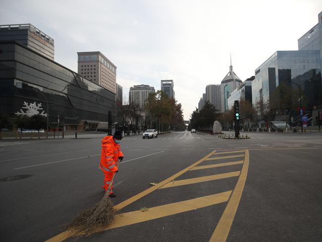 A sanitation worker sweeps a deserted road in Xi’an in China's northern Shaanxi province, amid a coronavirus lockdown in the city. Picture: AFP