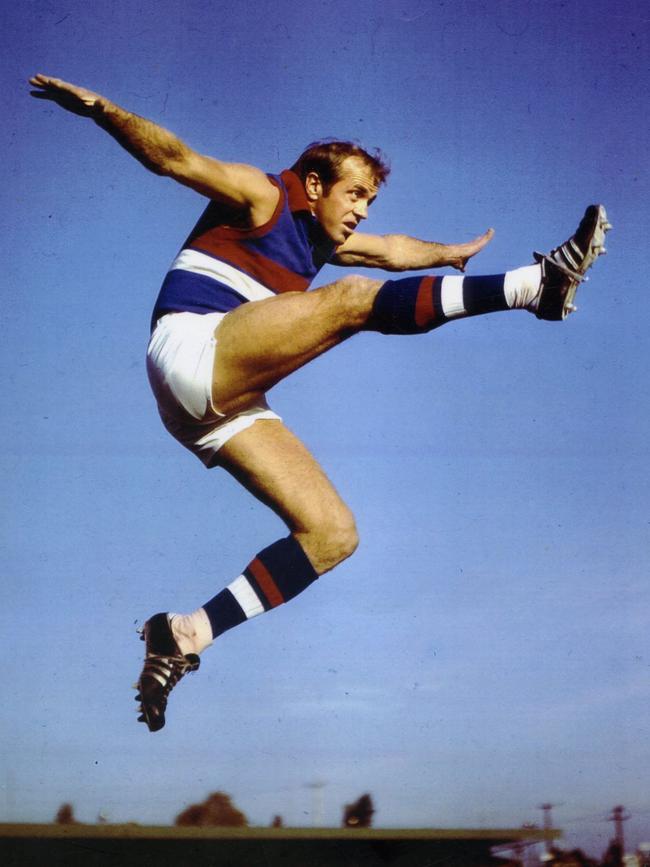 Footballer Ted Whitten in full flight.