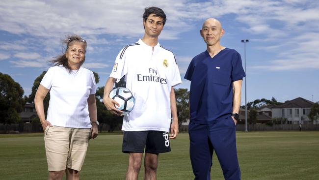 Teenager Nathan Fernandes , Mum Queen FernandoÃs and Dr  Nelson Low.  Nathan Fernandes collapsed in pain and spent the next 18 months housebound, barely able to walk and certainly not able to play soccer - he was a champion athlete.Mum Queenie took him to multiple doctors and specialists but no one could tell Nathan what was wrong and what was causing his excruciating calf pain. Queenie turned detective and worked in collaboration with Monash Children's Health Head of Paediatric Plastic Surgery Dr Nelson Low to discover that Nathan, now 16 and in Year 11, had a rare conditio n where the tibial nerve was compressed in his calf. Picture by Wayne Taylor 22nd February 2024