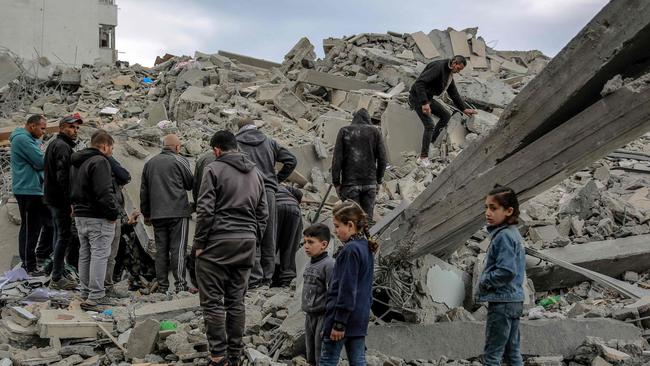 Palestinians inspect the rubble of a building, after it was destroyed in an Israeli strike in the Rimal neighbourhood of Gaza City. Picture: AFP.