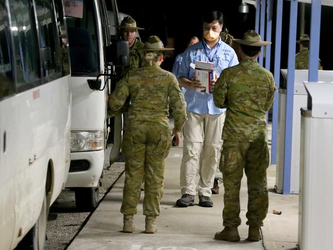 Teams from AUSMAT and the Australian Defence Force arrive at Christmas Island to meet the plane transporting Australian evacuees from Wuhan in China. Picture: Nathan Edwards