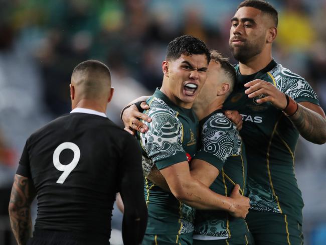 Noah Lolesio of the Wallabies celebrates with teammates after scoring a try. Picture: Matt King/Getty Images