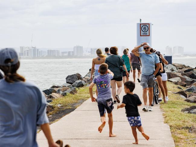 People at the break wall at Mooloolaba Spit to see the wild ocean whipped up by Cyclone Alfred. Picture Lachie Millard