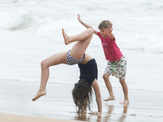 Princess Isabella, 10, and Prince Vincent, 6, did handstands on the beach. Princess Mary and her royal family hit Sydney’s Palm Beach for a dip before they head to Tasmania for an Aussie Christmas. Picture: Media Mode