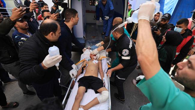 Medics care for injured Palestinians following Israeli bombardment, at the Kuwaiti Hospital in Rafah in the southern Gaza Strip on December 22, 2023, amid ongoing battles between Israel and the Palestinian militant group Hamas. (Photo by Mahmud HAMS / AFP)