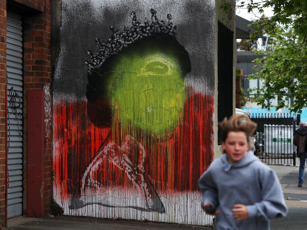 A mural of the late Queen Elizabeth II by artist Stuart Sale has been painted over in the colours of the Aboriginal flag. (Photo by Lisa Maree Williams/Getty Images)