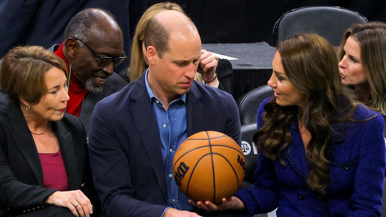 Britain's Prince William is handed a basketball by Catherine, Princess of Wales before the game. Picture: Brian Snyder / POOL / AFP