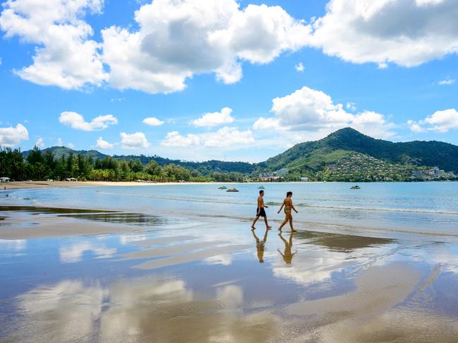 Tourists walk on a beach on the Thai island of Phuket, where Joshua Connell was found dead. Picture: AFP