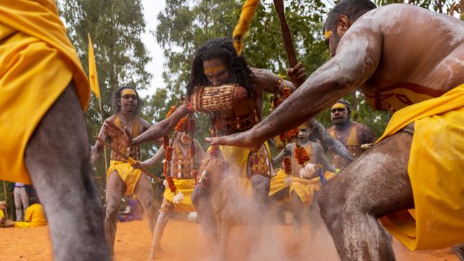 Cedric Yunupingu stamps out fire at the ceremonial opening of the 2022 Garma Festival. Picture: Getty Images