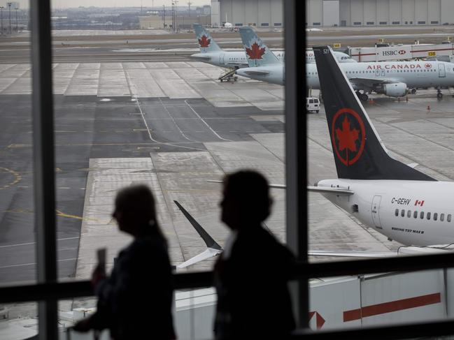 (FILES) In this file photo an Air Canada Boeing 737 MAX 8 jet tail is seen on the tarmac at Toronto Pearson International Airport on March 13, 2019 in Toronto, Canada. - Canada's transport ministry said on January 18, 2021 it has approved the Boeing 737 MAX to fly again in this country starting on January 20, 2021, ending a nearly two-year grounding following two deadly crashes. After a review of design changes and additional pilot training for the jetliner, Transport Canada said it 