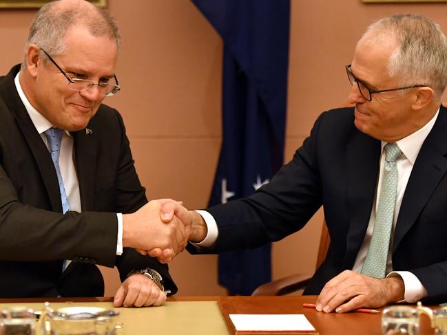 Treasurer Scott Morrison and Prime Minister Malcolm Turnbull shake hands at an Expenditure Review Committee meeting at Parliament House, Canberra, Monday, May 8, 2017. This is the last Expenditure Review Committee meeting before the Federal Budget is released on Tuesday. (AAP Image/Mick Tsikas) NO ARCHIVING