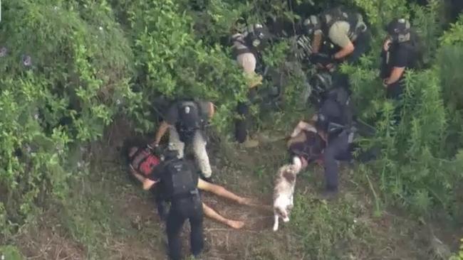 Cory James Glass and Tyrone Russell are arrested on a Kempsey riverbank. Picture: ABC