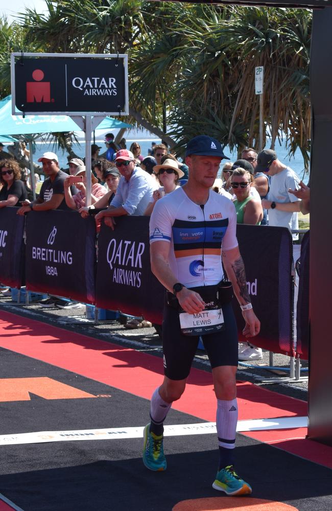 Athletes crossing the finish line at Sunshine Coast Ironman 70.3 2023.